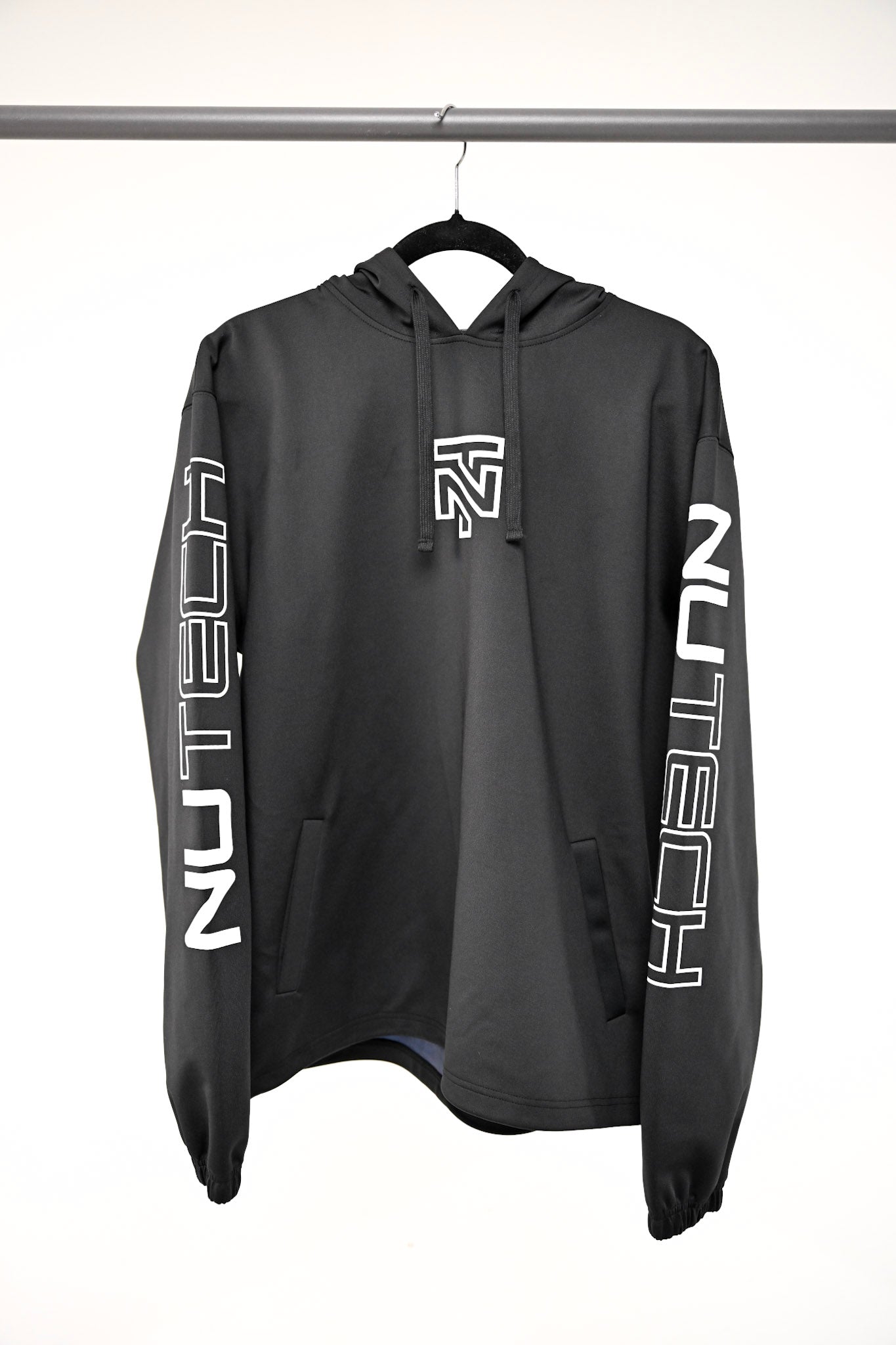 Black hoodie with white branding on sleeves, hanging against a white background. Engineered for high-intensity training
Advanced sweat-technology
Breathable fabric for temperature control
Athletic fit for unrestricted movement
Durable construction for repeated workouts
